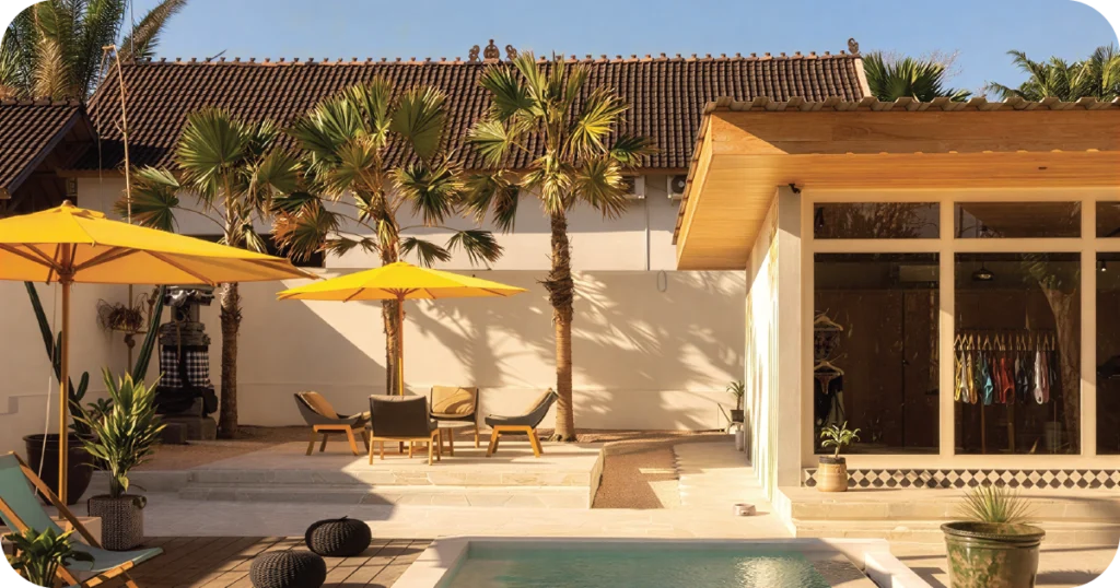 Gooseberry Restaurant Uluwatu: Poolside patio with yellow umbrellas, palms, and lounge chairs