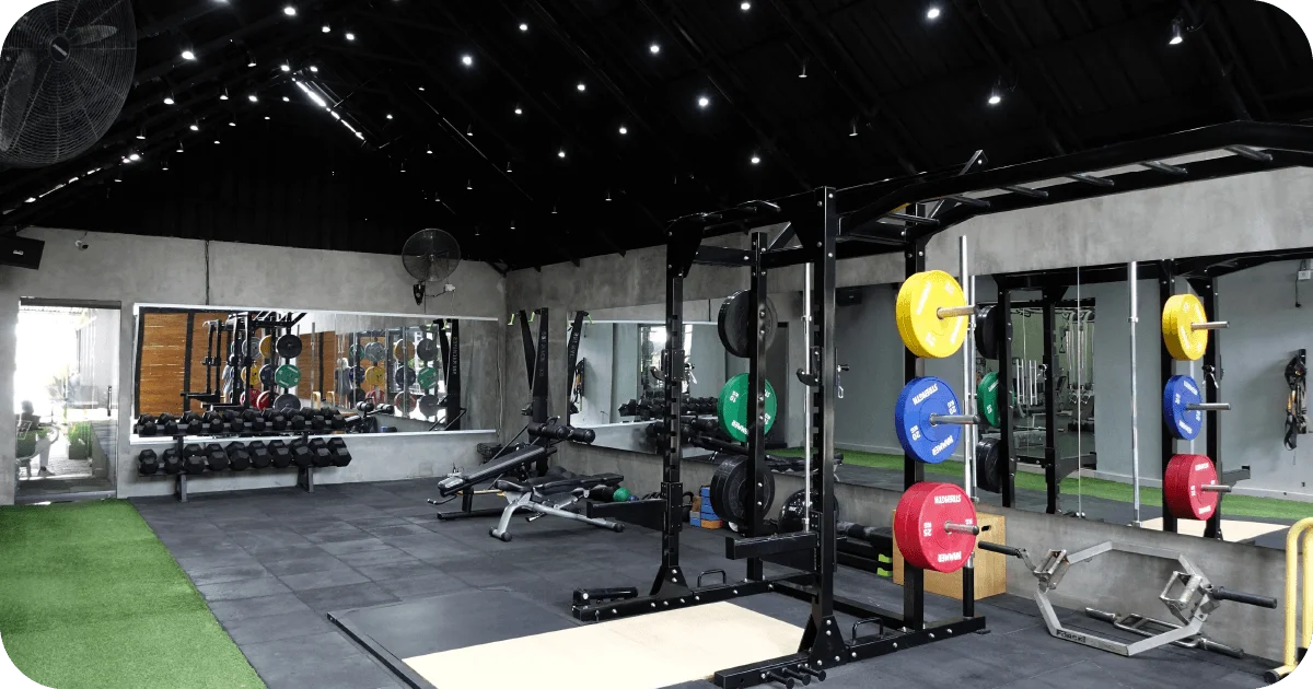Powerlifting area with squat rack, bumper plates, and mirrors