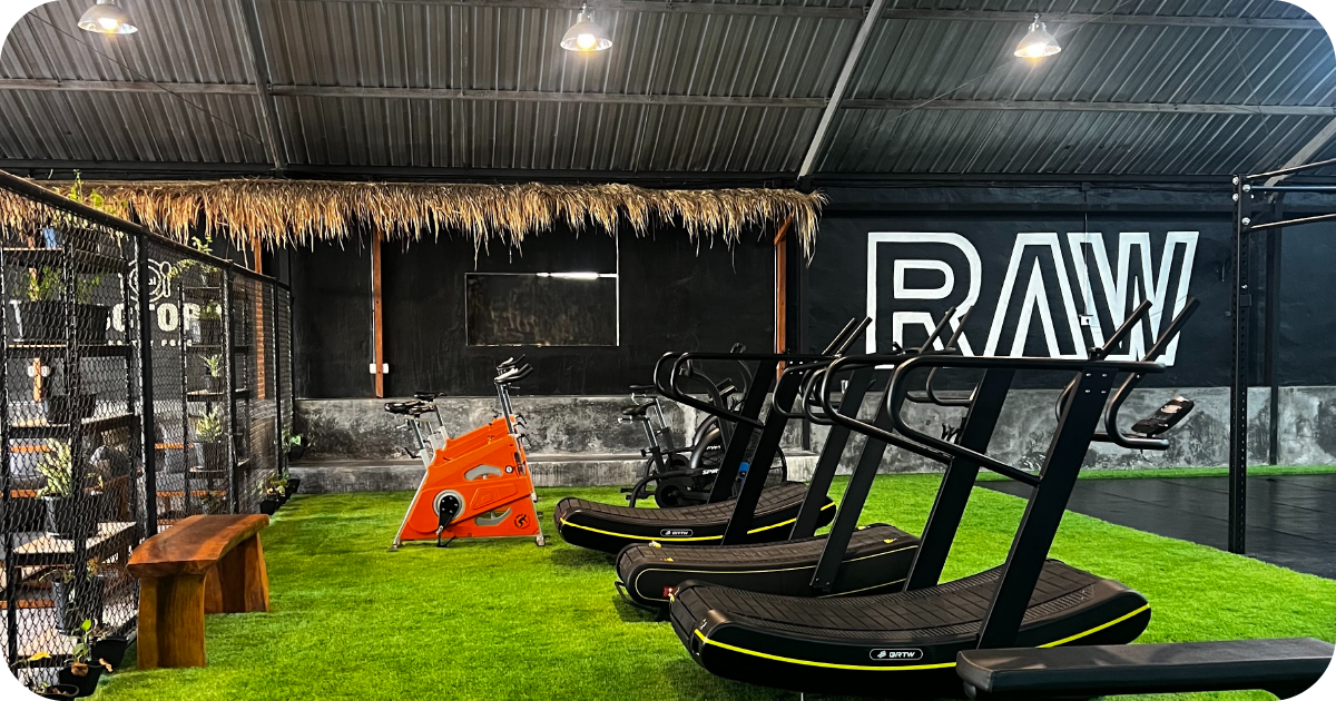 RAW cardio zone with curved treadmills, air bikes and turf