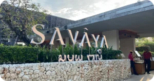 Savaya Bali Club: SAVAYA entrance sign beside stone wall and greenery