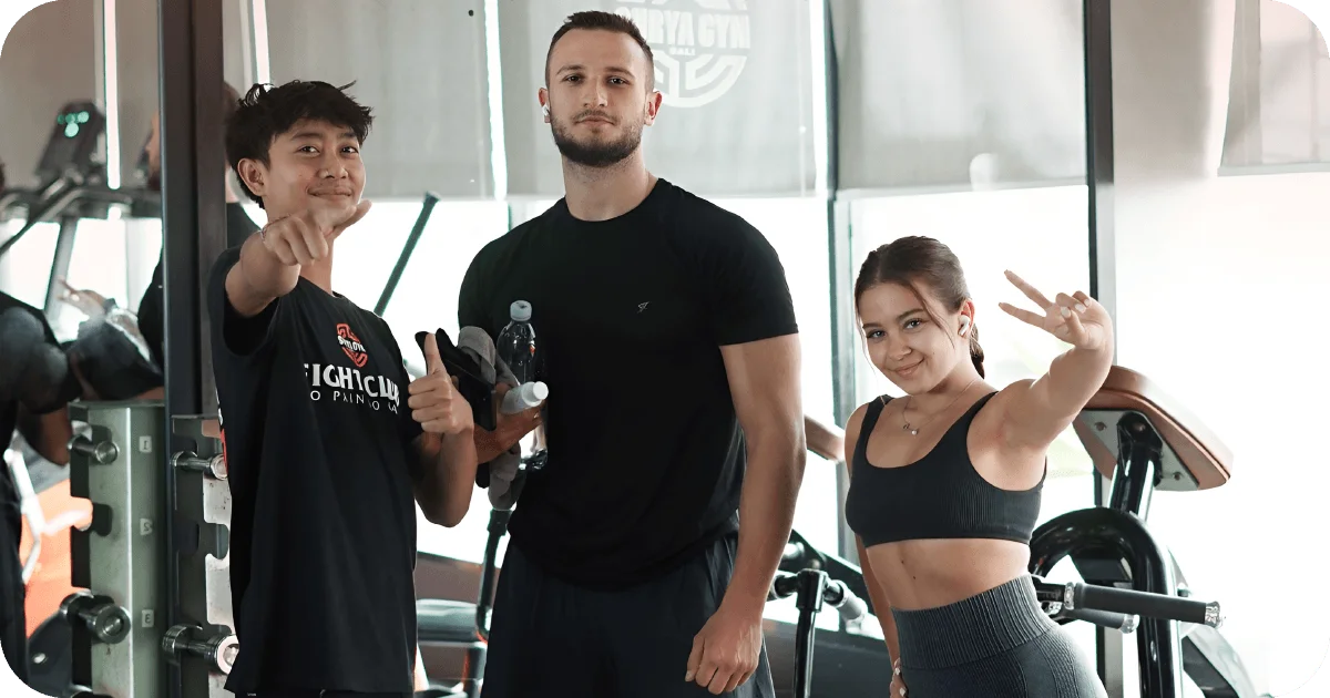 Surya Gym Bali: The Ultimate Review of Canggu's Premier Fitness Destination 7 Three gymgoers posing by equipment, mirrors in background