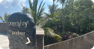 One Eighty Day Club: oneeighty° The Parlour stone sign amid tropical garden pathway