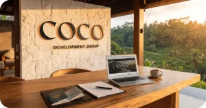 Bali Investor Guide: COCO Development Group signage, wooden desk with laptop, coffee, rice-terrace view